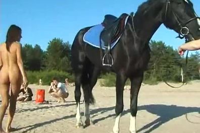 Naked teen riding a horse at the beach turns heads